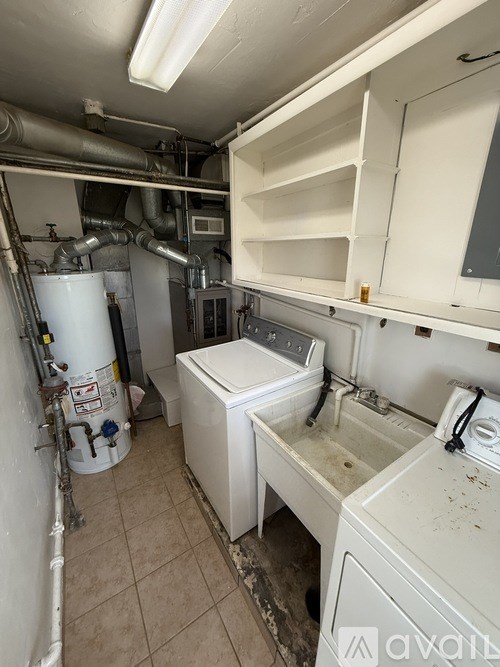 A dirty laundry room with a washer and dryer.
