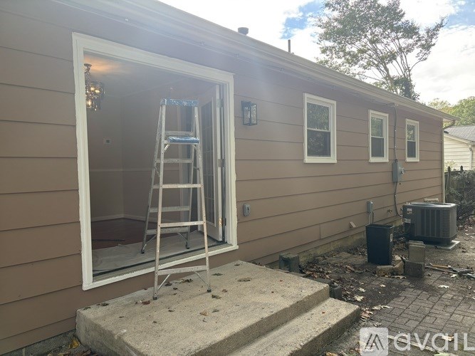 A ladder is leaning against a house's window.