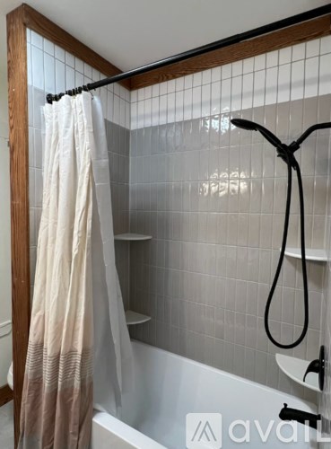 A white bathroom with a white tub and a white shower curtain.