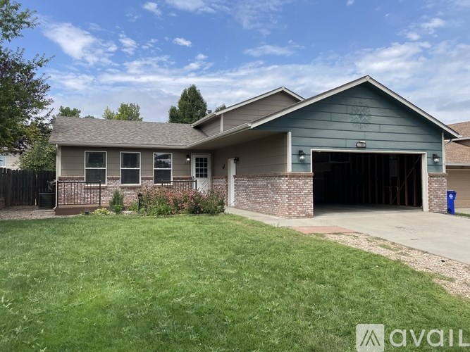A house with a garage and a driveway in front.