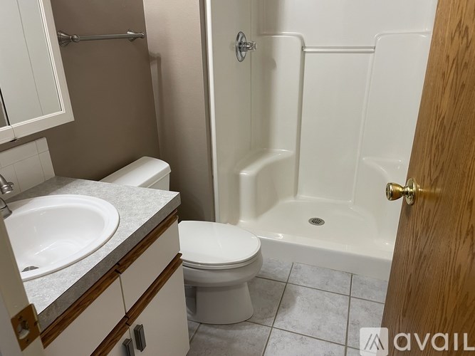 A bathroom with a toilet, sink, and bathtub.