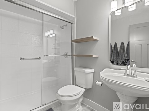 A white toilet sits next to a sink in a bathroom.