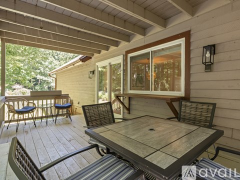 A wooden deck with a table and chairs.