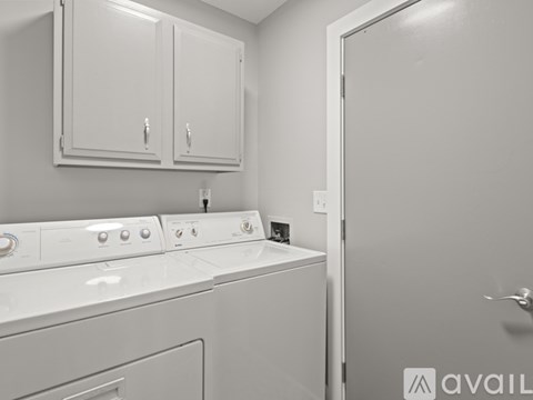 A white washing machine and dryer in a laundry room.