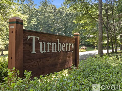 A brown sign with the word Turnberry on it in white letters.