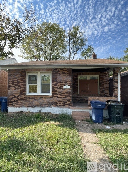 A house with a brown brick exterior and a white window.