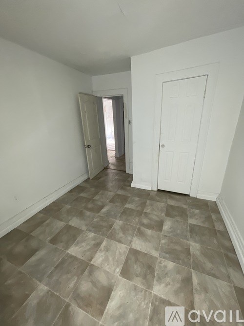 A room with a tiled floor and white walls.