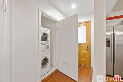 A laundry room with a washer and dryer in it.