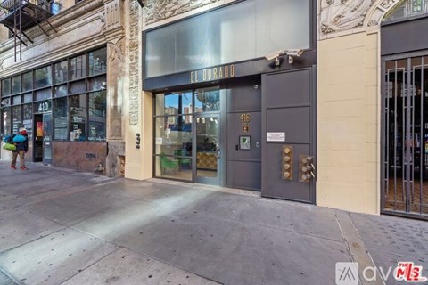 The front of a building with a glass door and a sign that reads "El Horrado".