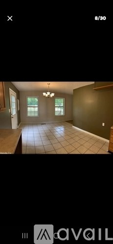 A room with tiled flooring and a chandelier.