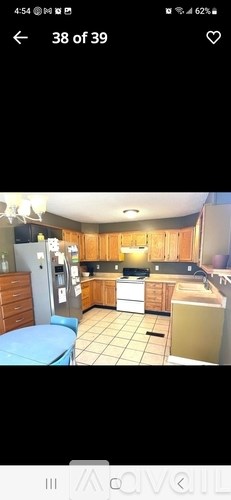 A kitchen with wooden cabinets and a white refrigerator.
