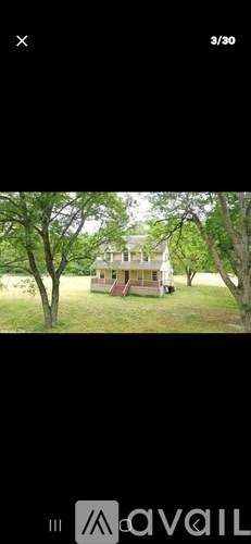 A house is surrounded by trees and grass.