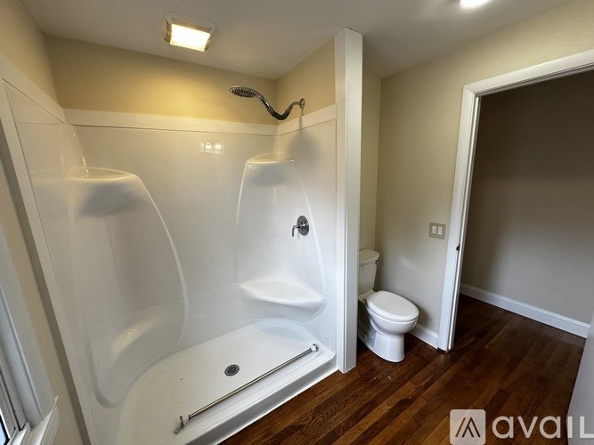 A bathroom with a white tub and toilet.