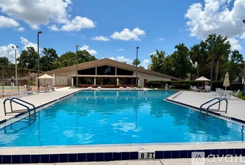 A large outdoor swimming pool with a building in the background.