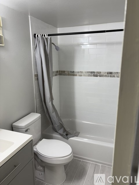 A white toilet sits next to a white sink in a bathroom.