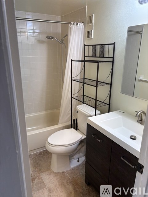 A bathroom with a toilet, sink, and bathtub.