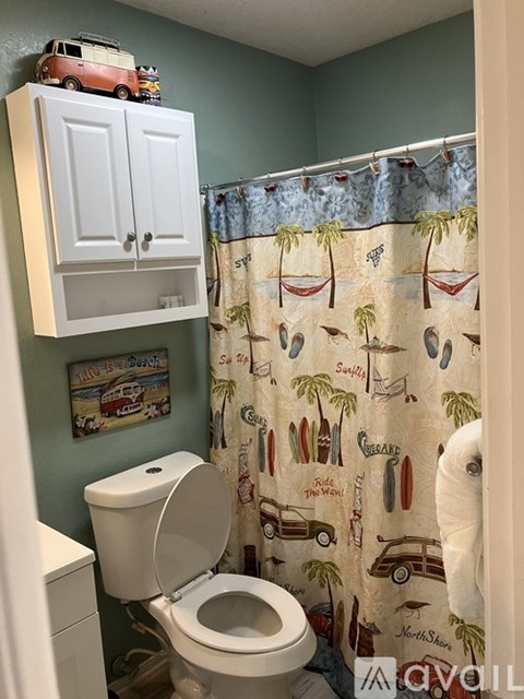 A toy car is on top of a white medicine cabinet.