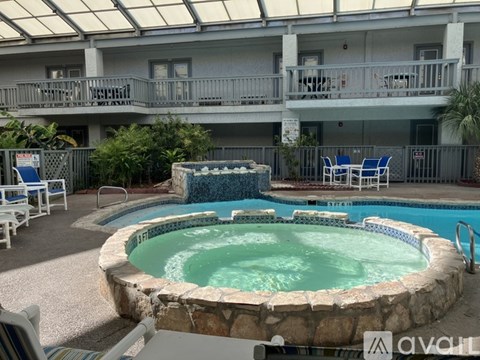 A pool with a hot tub in the middle of it.