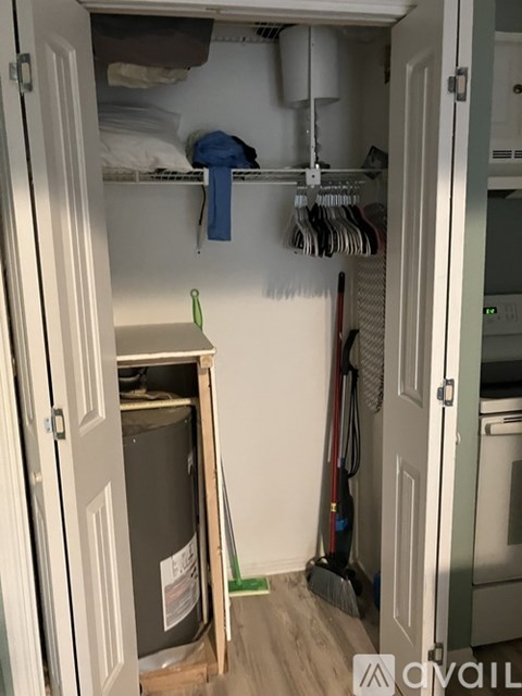 A small closet with a washer and dryer in it.