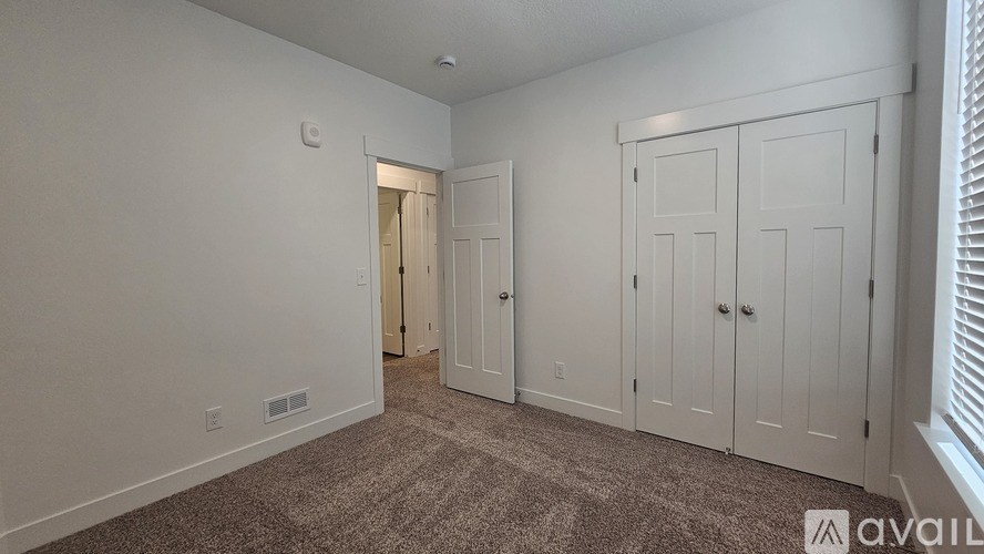 A room with a carpeted floor and white walls.
