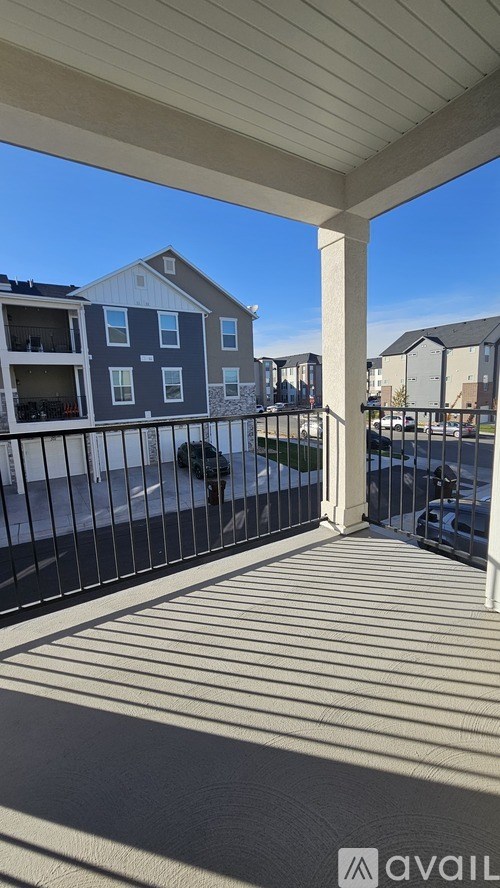 A balcony with a view of apartment buildings.