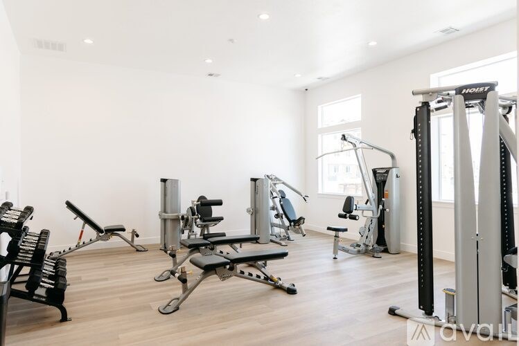 A gym with a variety of equipment including a leg press machine.