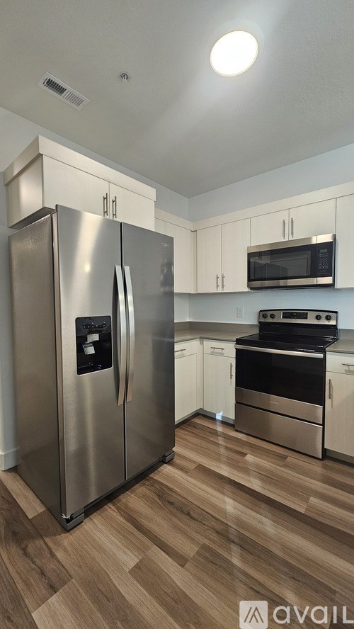 A kitchen with a stainless steel refrigerator and oven.