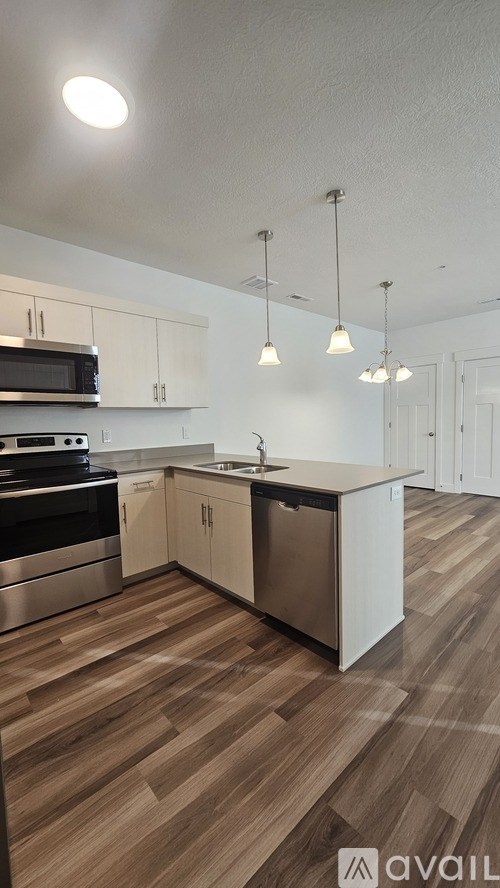 A kitchen with wooden floors and white walls.