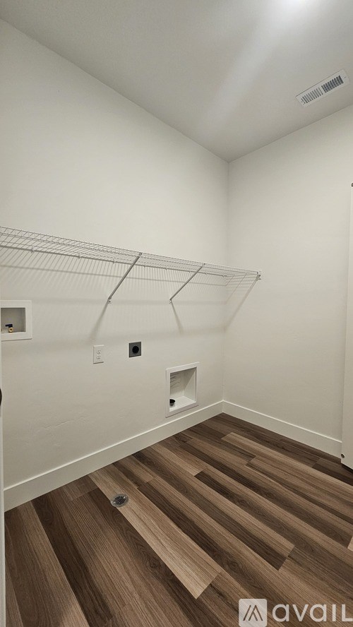 Empty room with wooden floors and white walls.