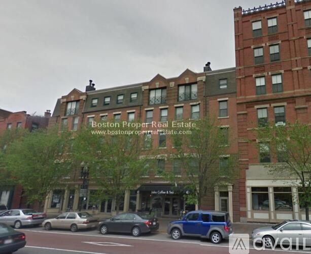 A street view of a city with cars and buildings.