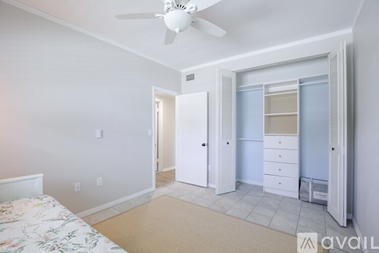 A bedroom with a bed, dresser, and closet.