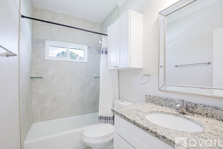 A bathroom with a toilet, sink, and shower.