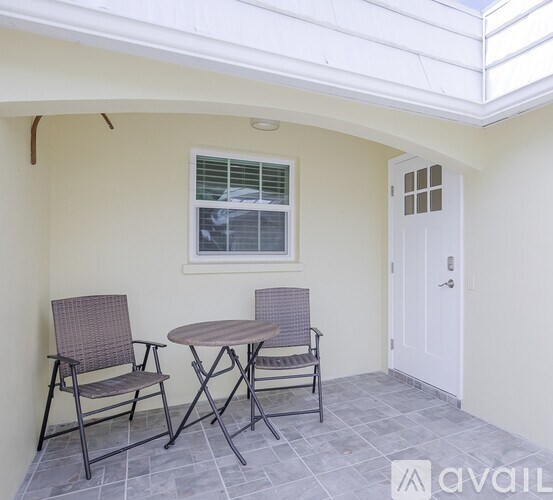 A patio with a table and two chairs.