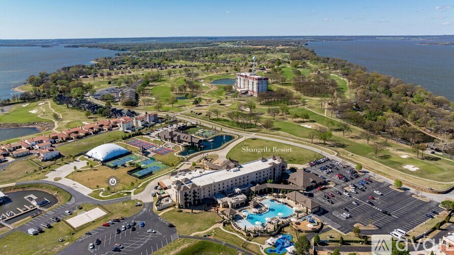 Shangri-La resort with a large swimming pool and a parking lot.