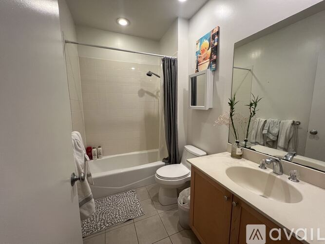 A bathroom with a white tub, toilet, and sink.
