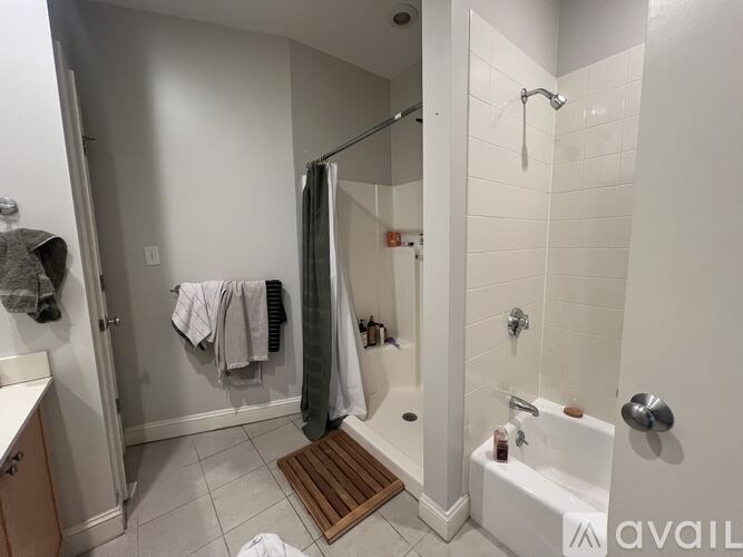 A bathroom with a white tub and a walk in shower.