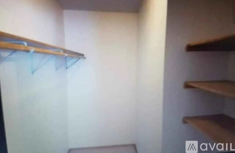 A small room with a shelf and a hanging clothesline.