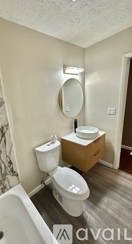 A room with a window and wooden flooring.