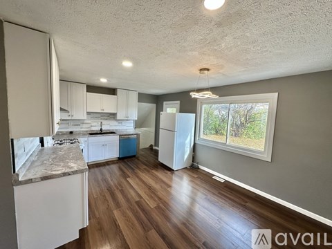 A wall-mounted heating unit with a grey base and a yellow caution label.