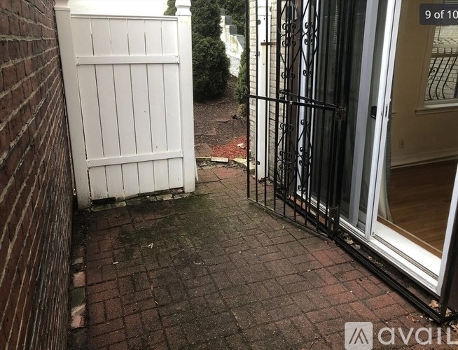 A white gate is closed and locked.