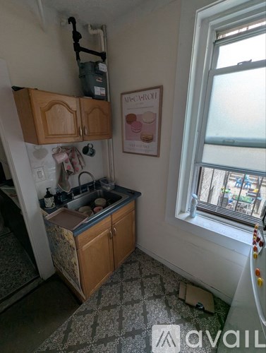 A kitchen with a sink and a window.