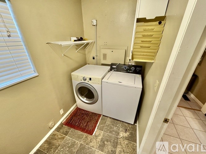 A small laundry room with a washer and dryer.