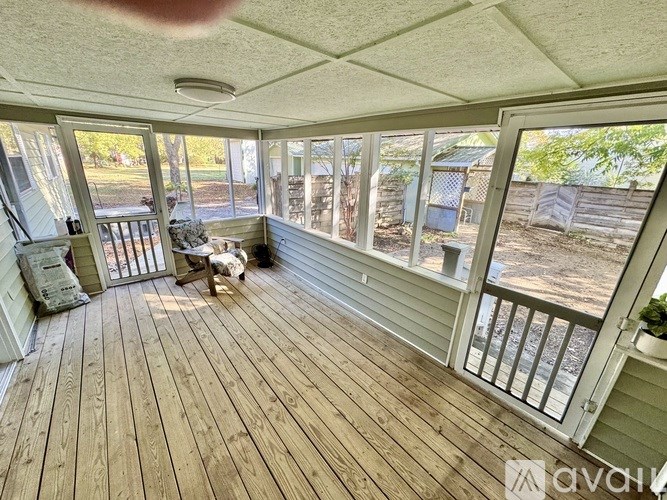 A sunny day at the backyard with a wooden deck.