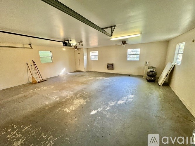 A large empty room with a concrete floor and white walls.