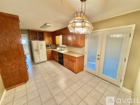 A kitchen with wooden cabinets and a white refrigerator.
