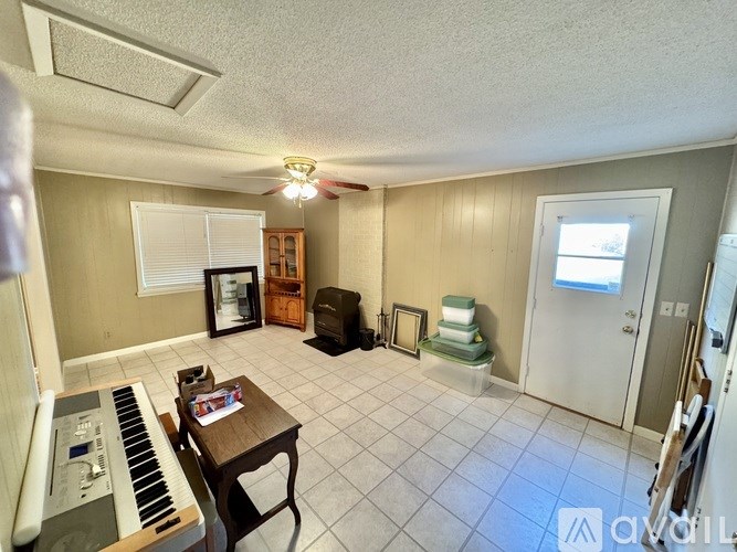 A living room with a piano and a chair.
