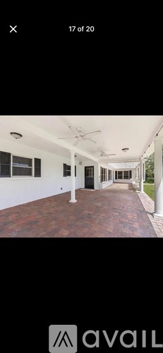 A white room with a ceiling fan and a door.