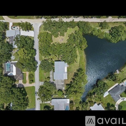 A bird's eye view of a residential area with a river running through it.