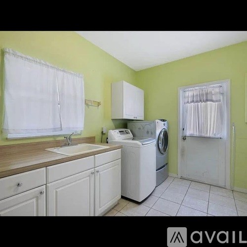 A small laundry room with a washer and dryer.