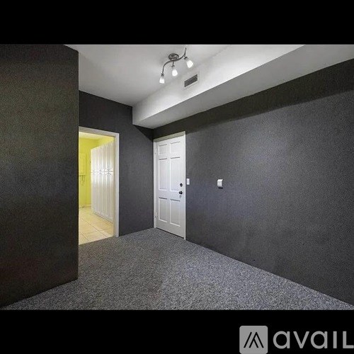 A room with grey walls and a white door.